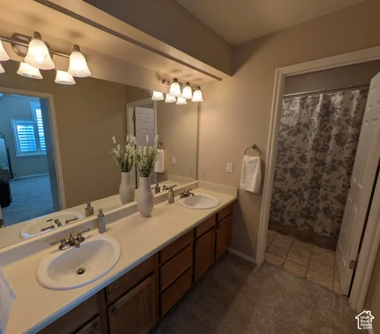 Dual vanity with integrated sinks, wood-finish cabinetry, and a full-width mirror