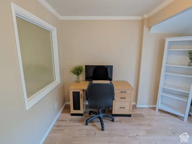 Crown molding, wood-finish flooring, and light-toned wall paint
