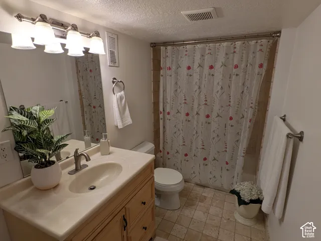 Single vanity with integrated sink, brushed nickel faucet, and wood-finish cabinetry