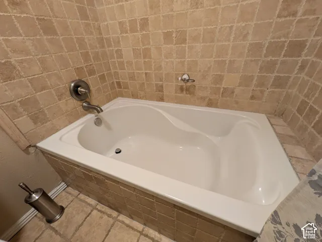 Soaking tub with tile surround and brushed nickel fixtures