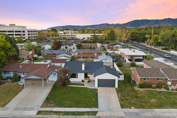 Single-story residence with a two-car garage, concrete driveway, and front lawn