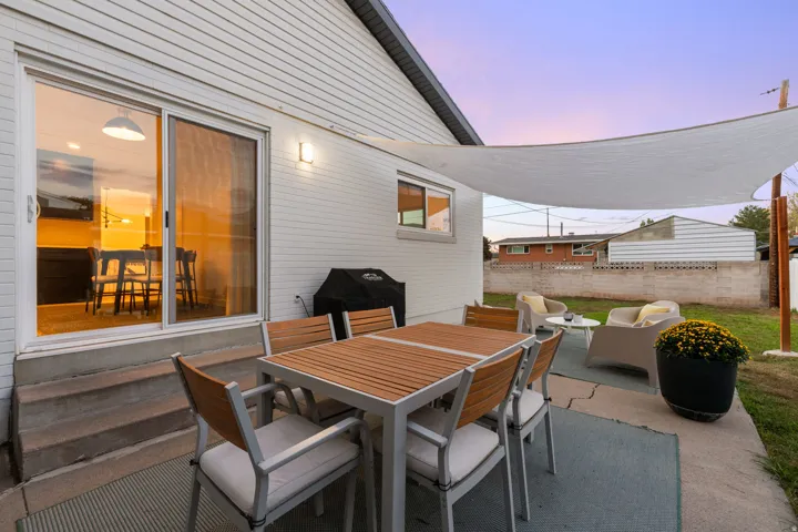 Sliding glass door access to an outdoor patio with concrete pavers
