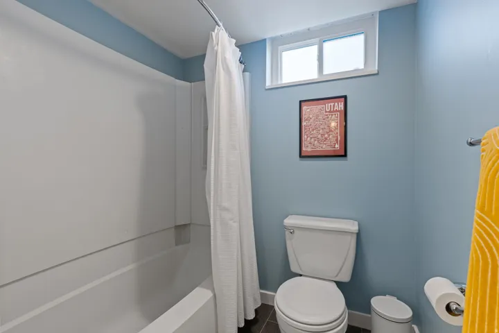 White bathtub and shower surround with a curved shower rod
