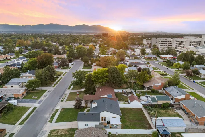 Residential neighborhood with mature trees and mountain scenery