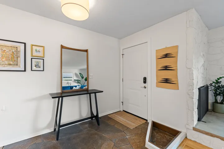 White paneled entry door with smart lock