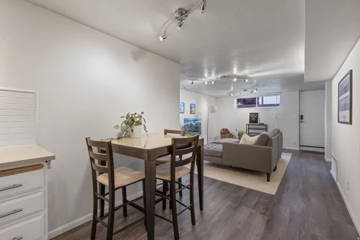 Wood-finish flooring throughout, track lighting, and a neutral color palette