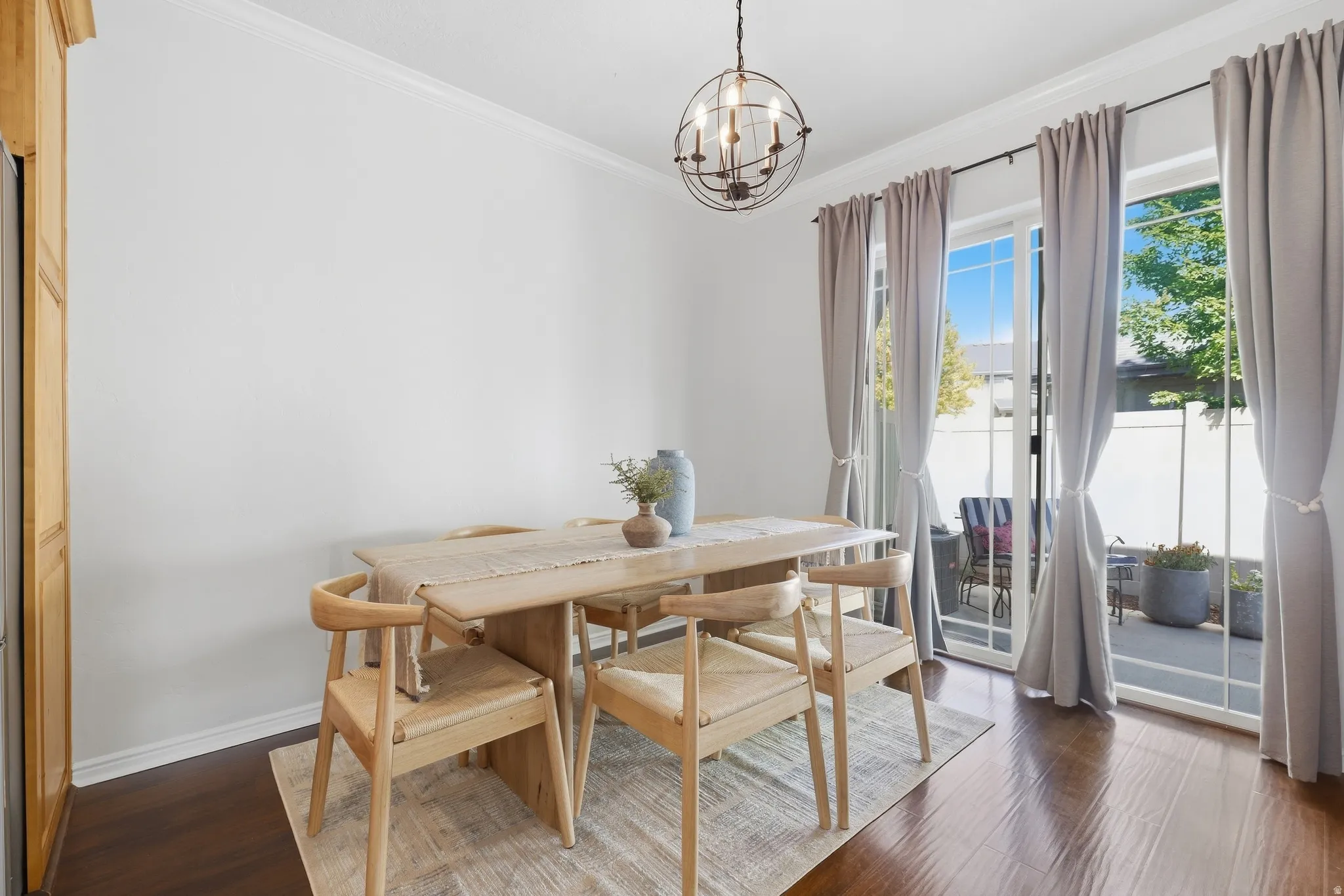 Dark wood-finish flooring with crisp white crown molding