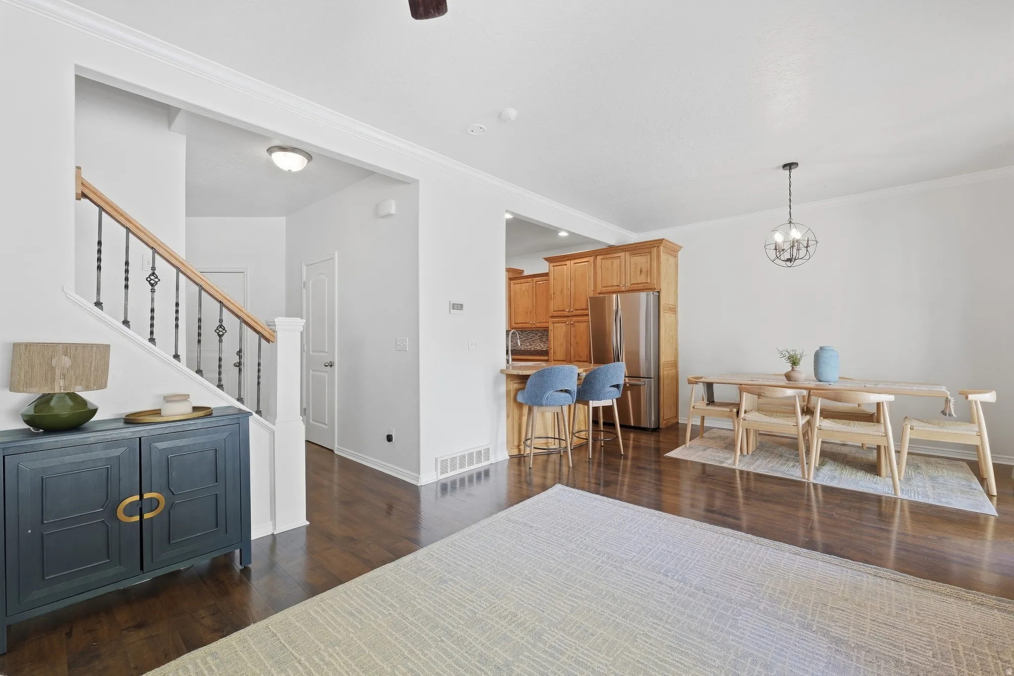 Hardwood-finish flooring throughout, featuring a staircase with decorative metal balusters and a wood handrail