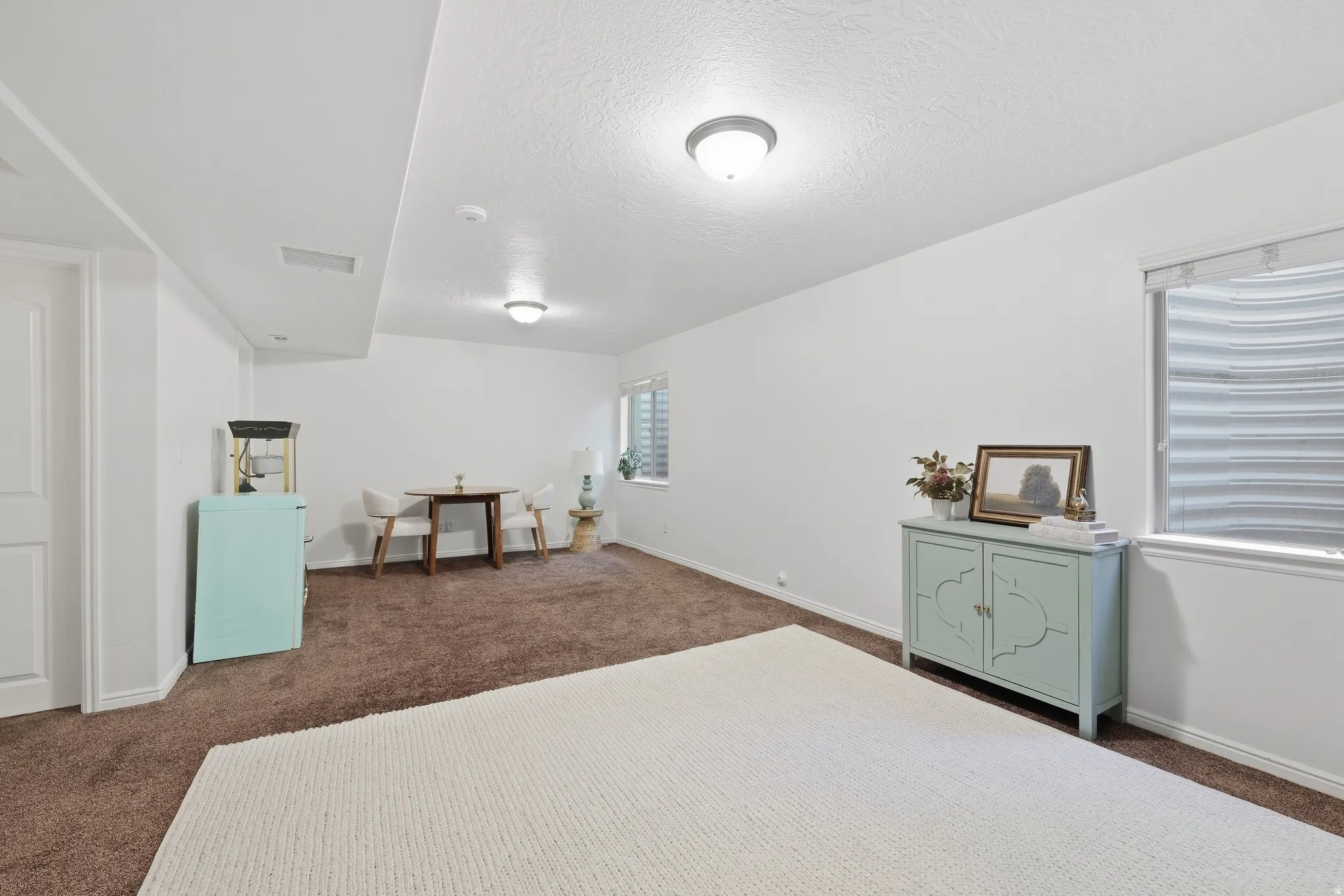 Carpeted flooring, recessed lighting, and built-in window wells