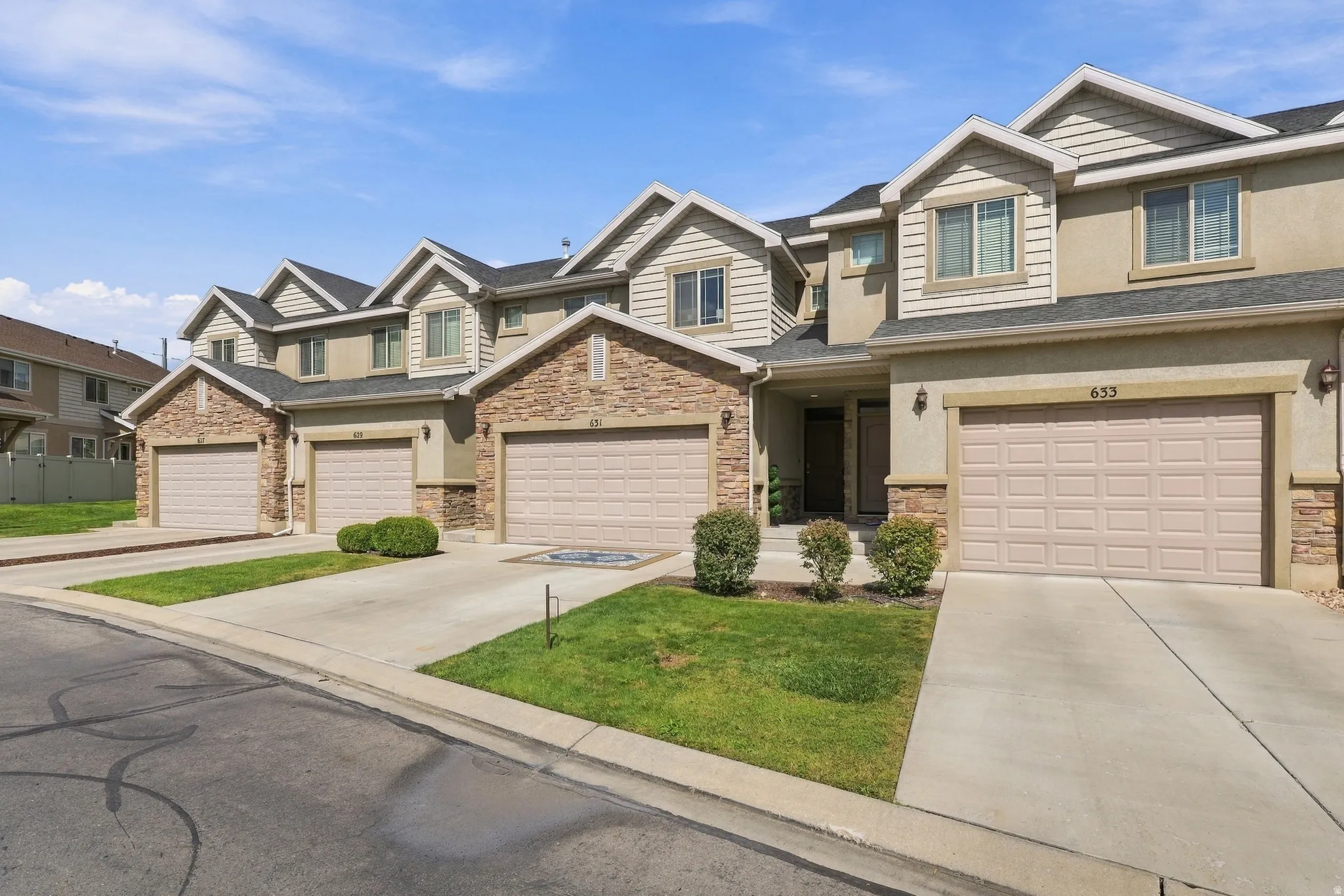 Stucco and stone exterior with architectural shingles