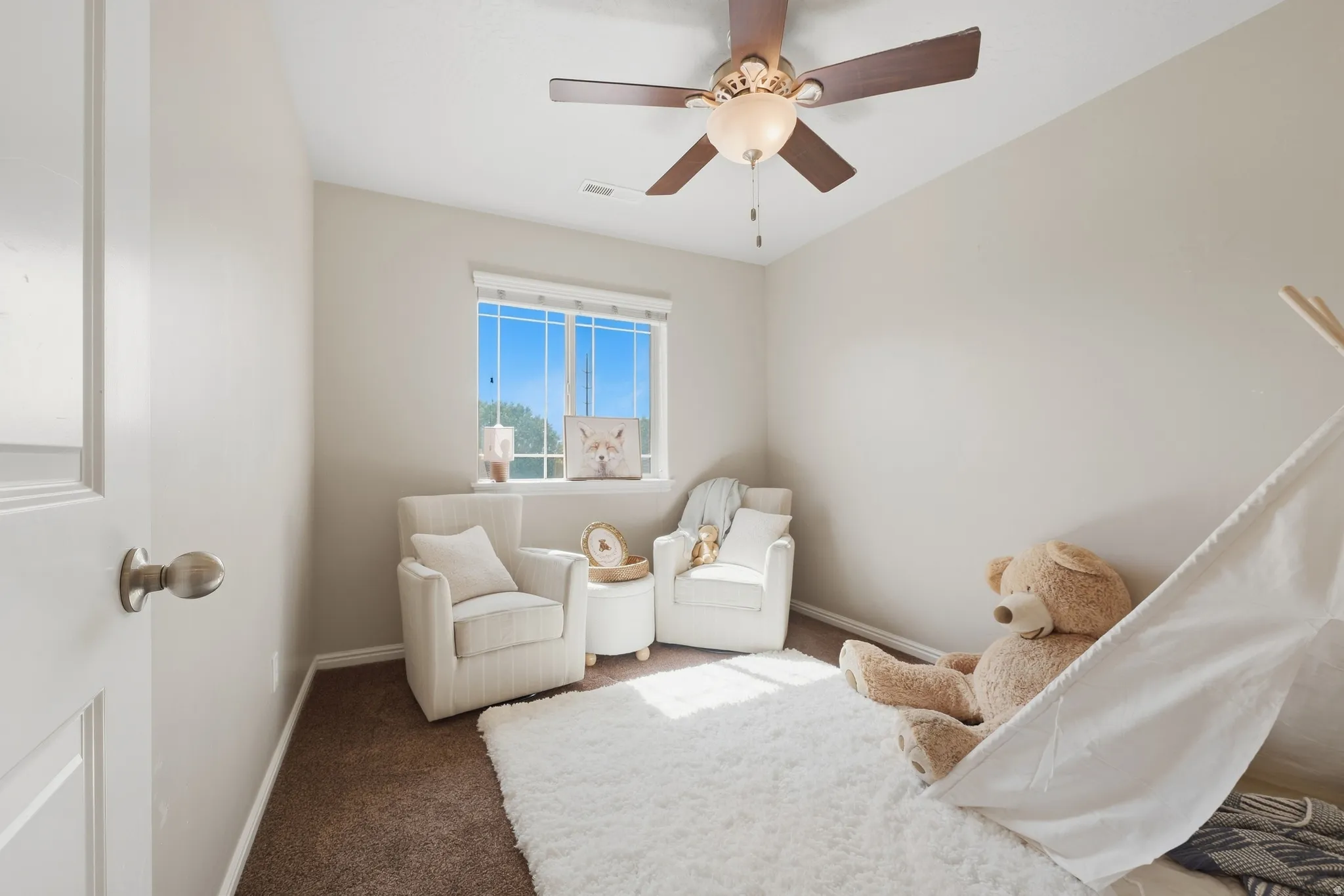 Recessed window with natural light, ceiling fan with integrated lighting, and neutral wall tones