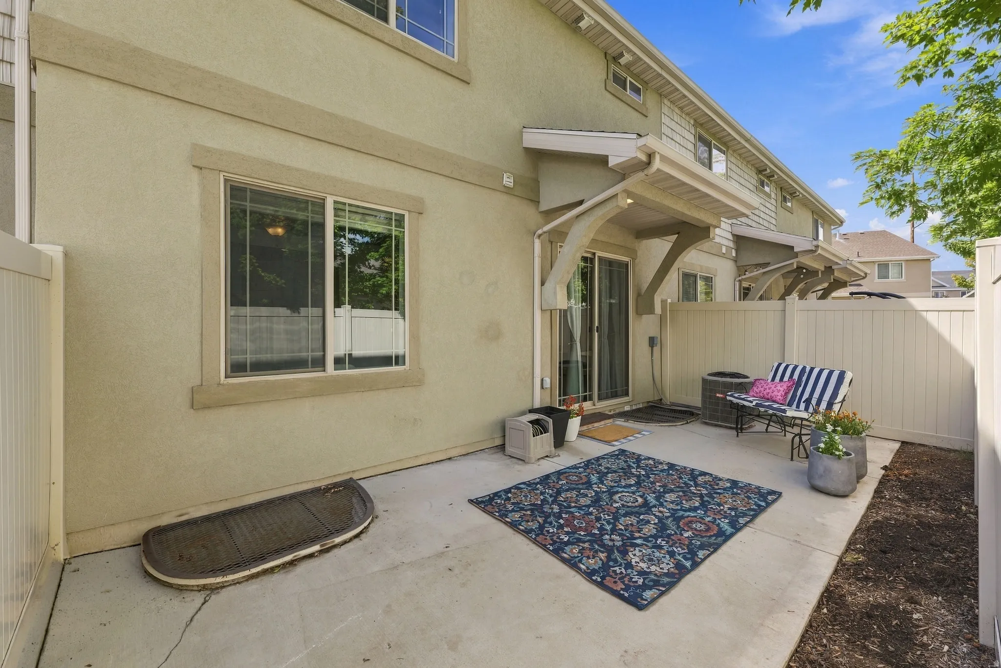 Private patio space featuring a concrete slab and vinyl fencing