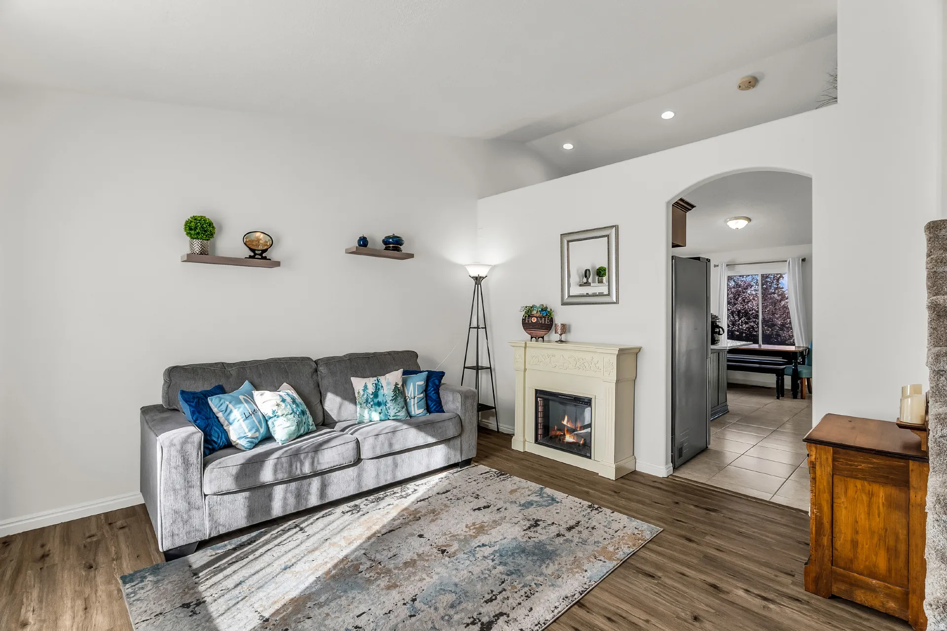 Open living room with lots of natural light, updated paint and LVP flooring. Vaulted ceilings and recessed lighting.
