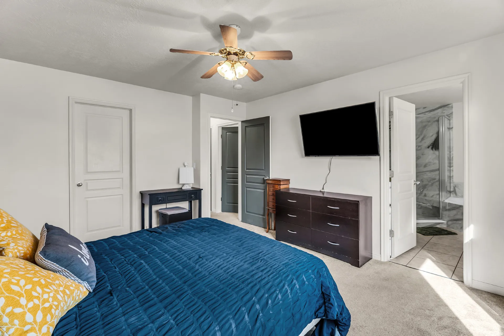 Large owners suite with new carpet, walk in closet and ceiling fan.
