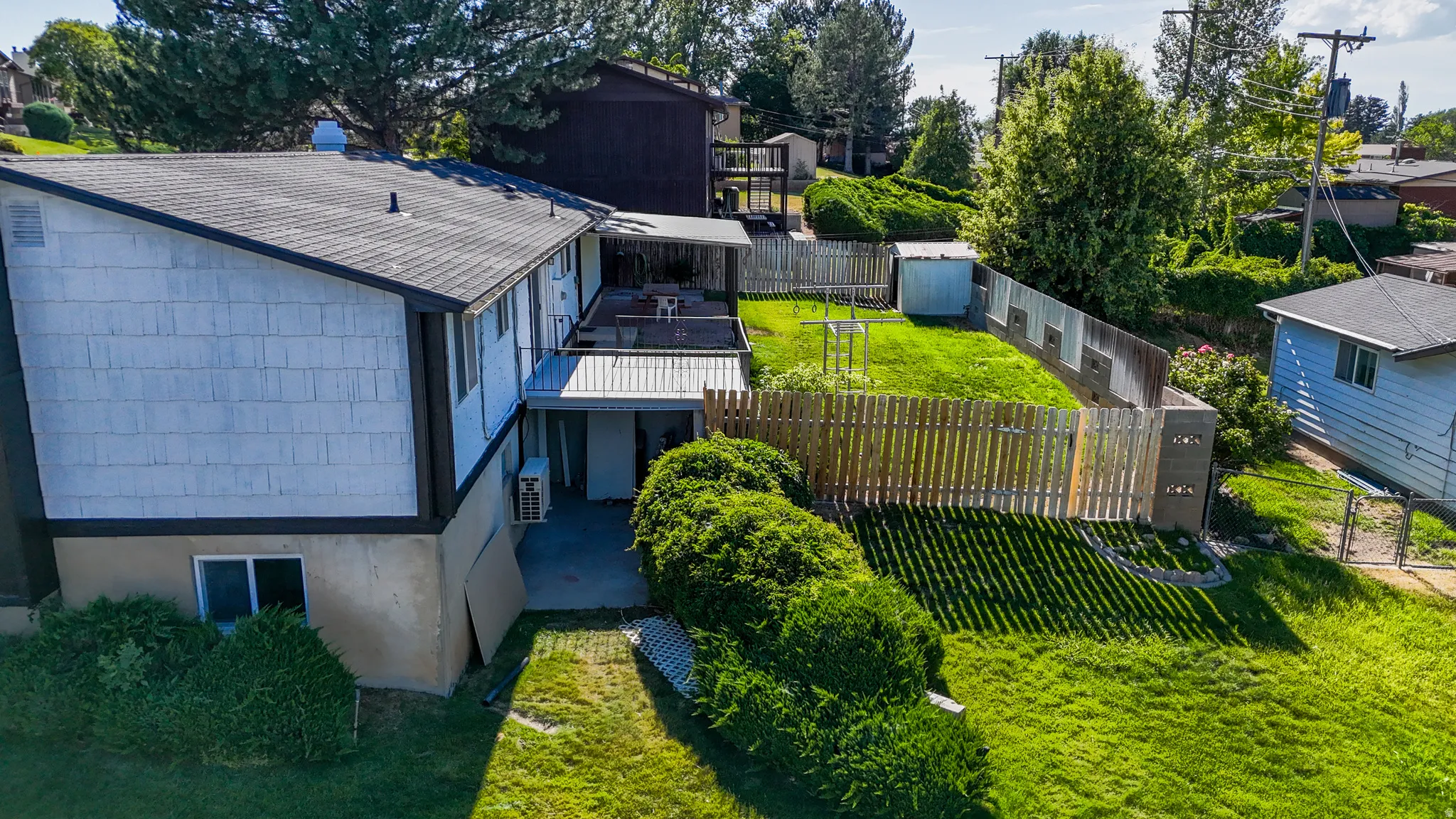 Multi-level exterior with shingle siding and a dark shingle roof