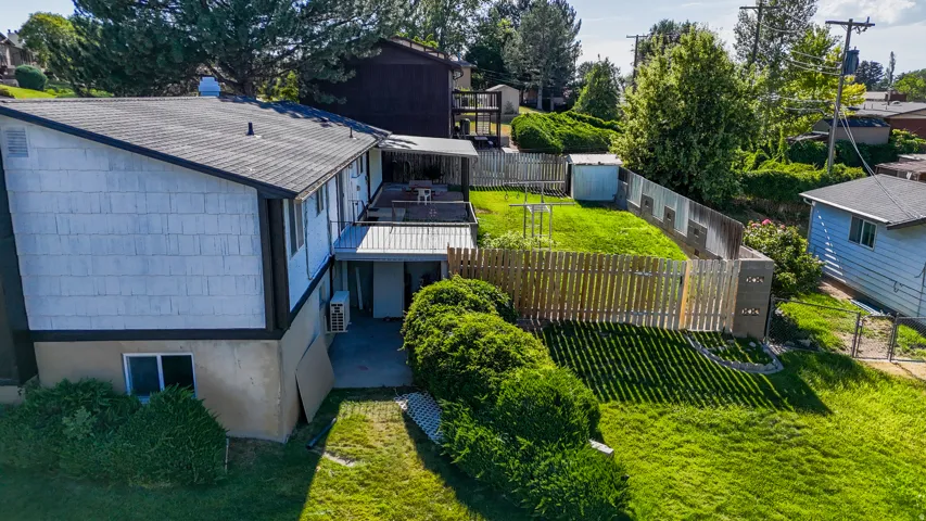 Multi-level exterior with shingle siding and a dark shingle roof