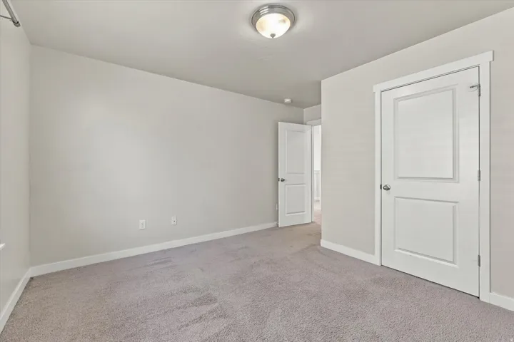 Neutral-toned carpet flooring and light gray wall finishes