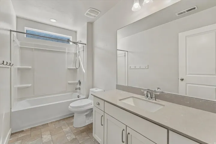 White vanity with integrated sink and chrome faucet