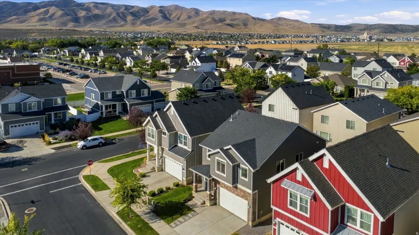 Residential neighborhood with varied architectural styles and mountain backdrop