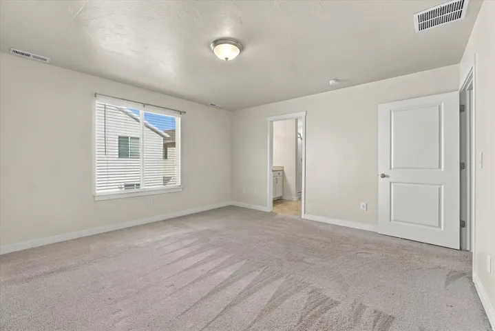 Wall-to-wall carpeting, overhead lighting, and white trim