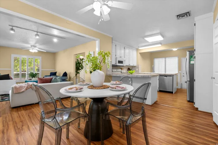 Open concept living area with wood-finish flooring