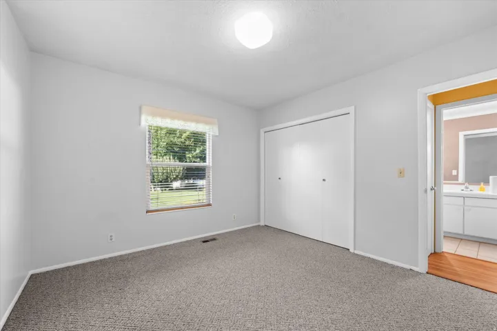 Gray textured carpeting and white painted walls