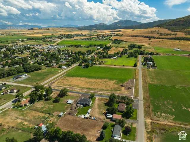 Expansive rural setting with a clear sky and distant mountains