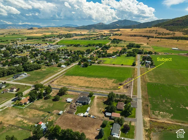 Rural setting featuring expansive green fields and distant mountains