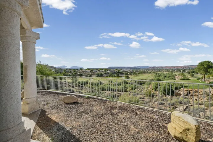 Expansive outdoor space featuring a decorative railing and decorative columns