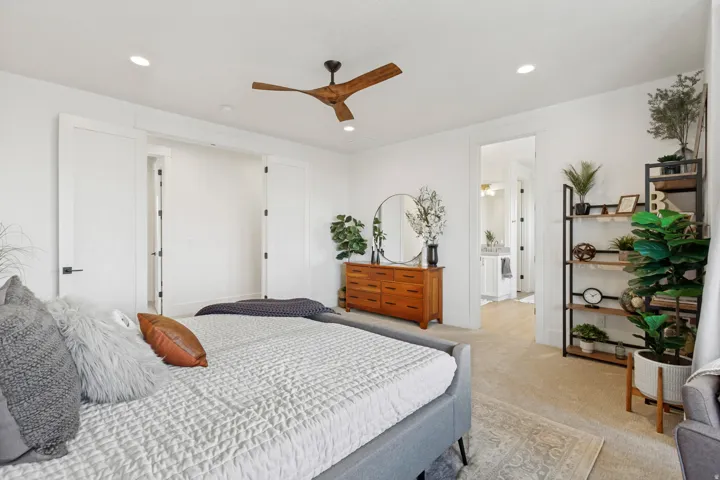 Recessed lighting, wood-finish ceiling fan, and carpeted flooring