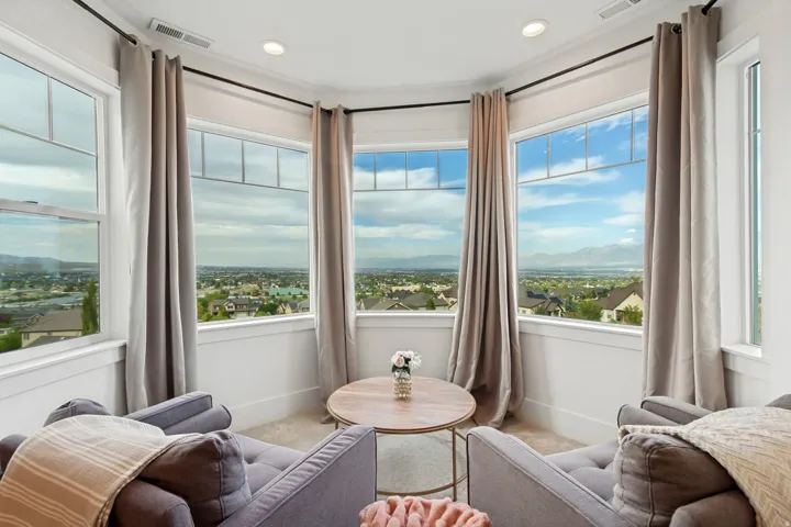 Bay window with multiple large windows, recessed lighting, and crown molding