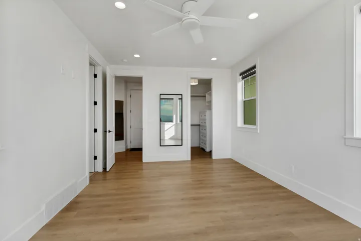 Wood-finish flooring with white walls and trim