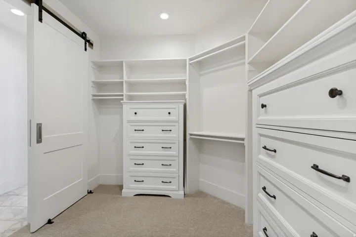Custom closet system featuring built-in shelving, hanging rods, and integrated drawer storage