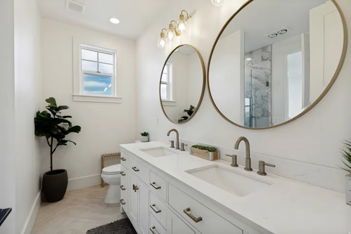 Dual vanity with white cabinetry, integrated sinks, and brushed nickel fixtures