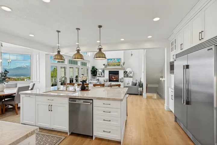 Expansive kitchen island with a stone-finish countertop and undermount sink