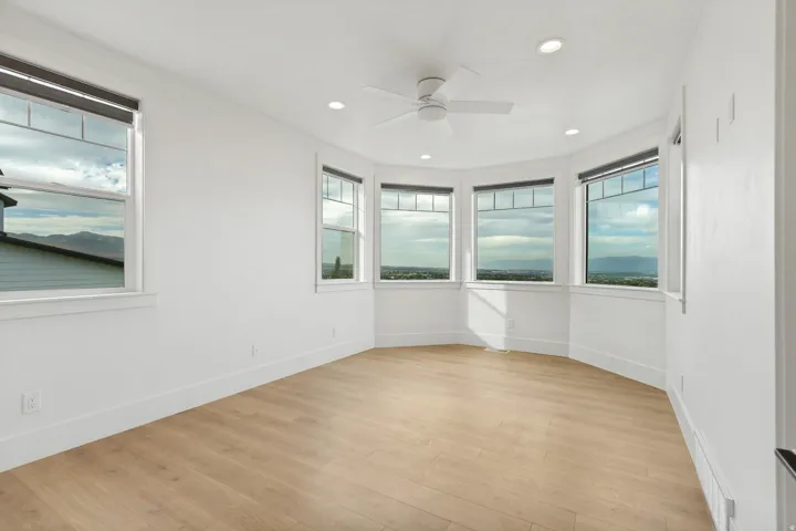 Wood-finish flooring with white walls and trim