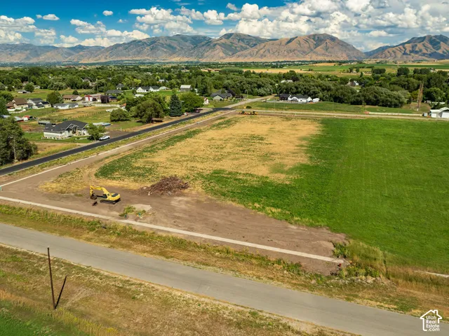 Expansive land parcel featuring partial green space and mountain scenery