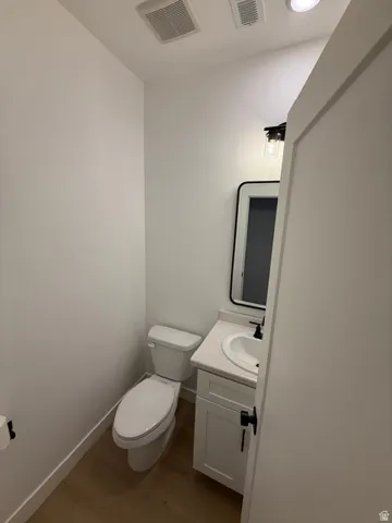 White shaker vanity with a solid surface countertop and undermount sink