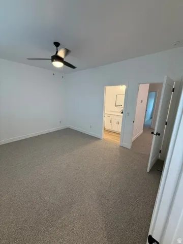Recessed lighting, ceiling fan, neutral wall colors, carpet flooring, and a flat panel door