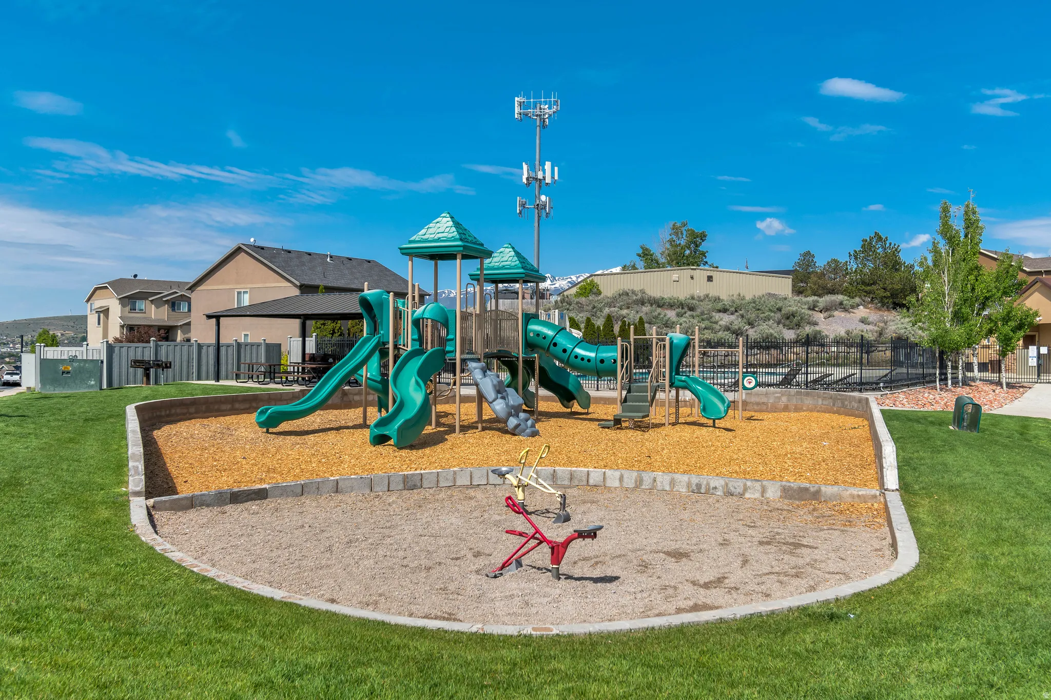 Community playground featuring slides, climbing structures, and a spring rider