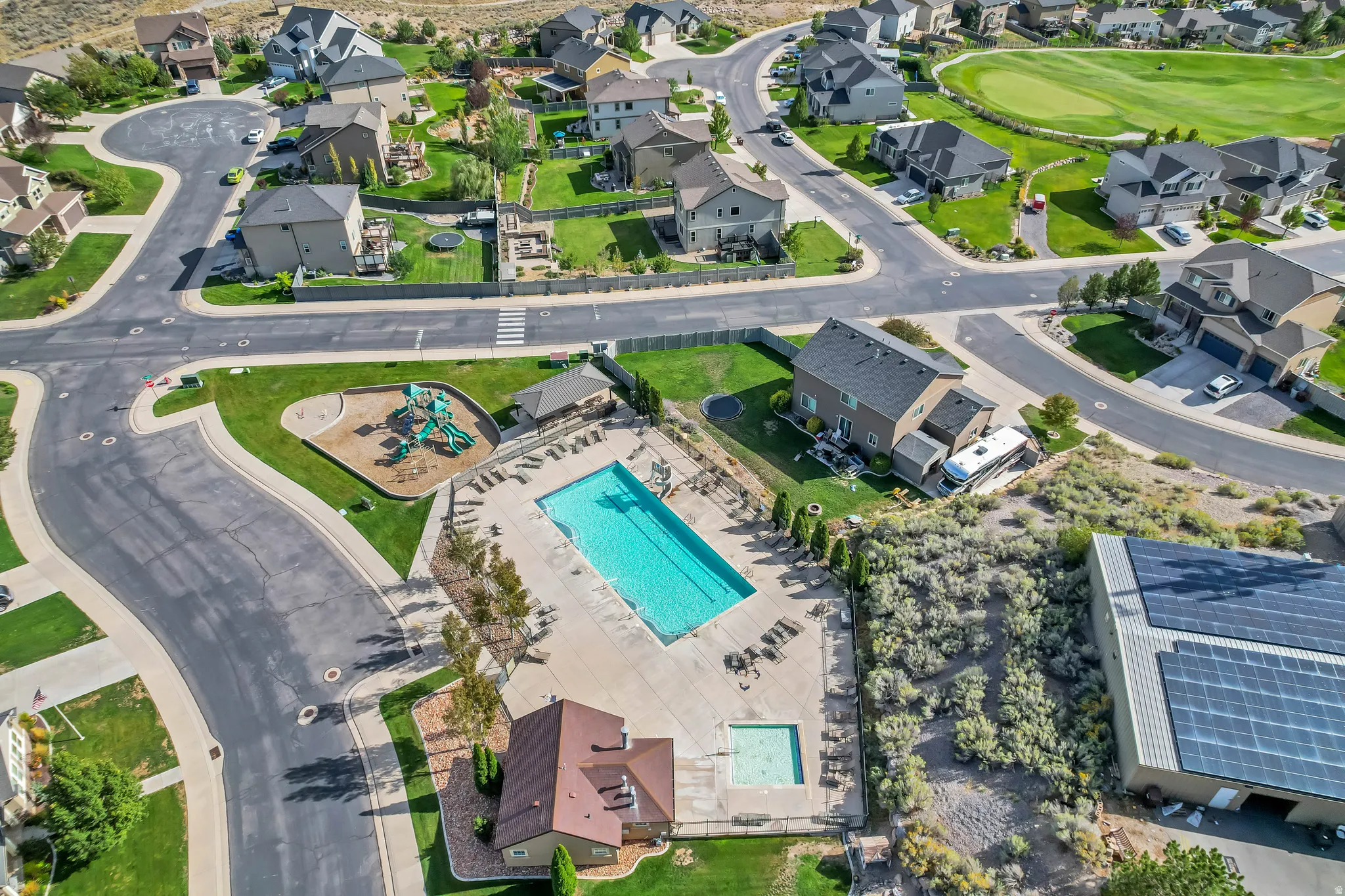 Community with a swimming pool, adjacent children's playground, and nearby golf course