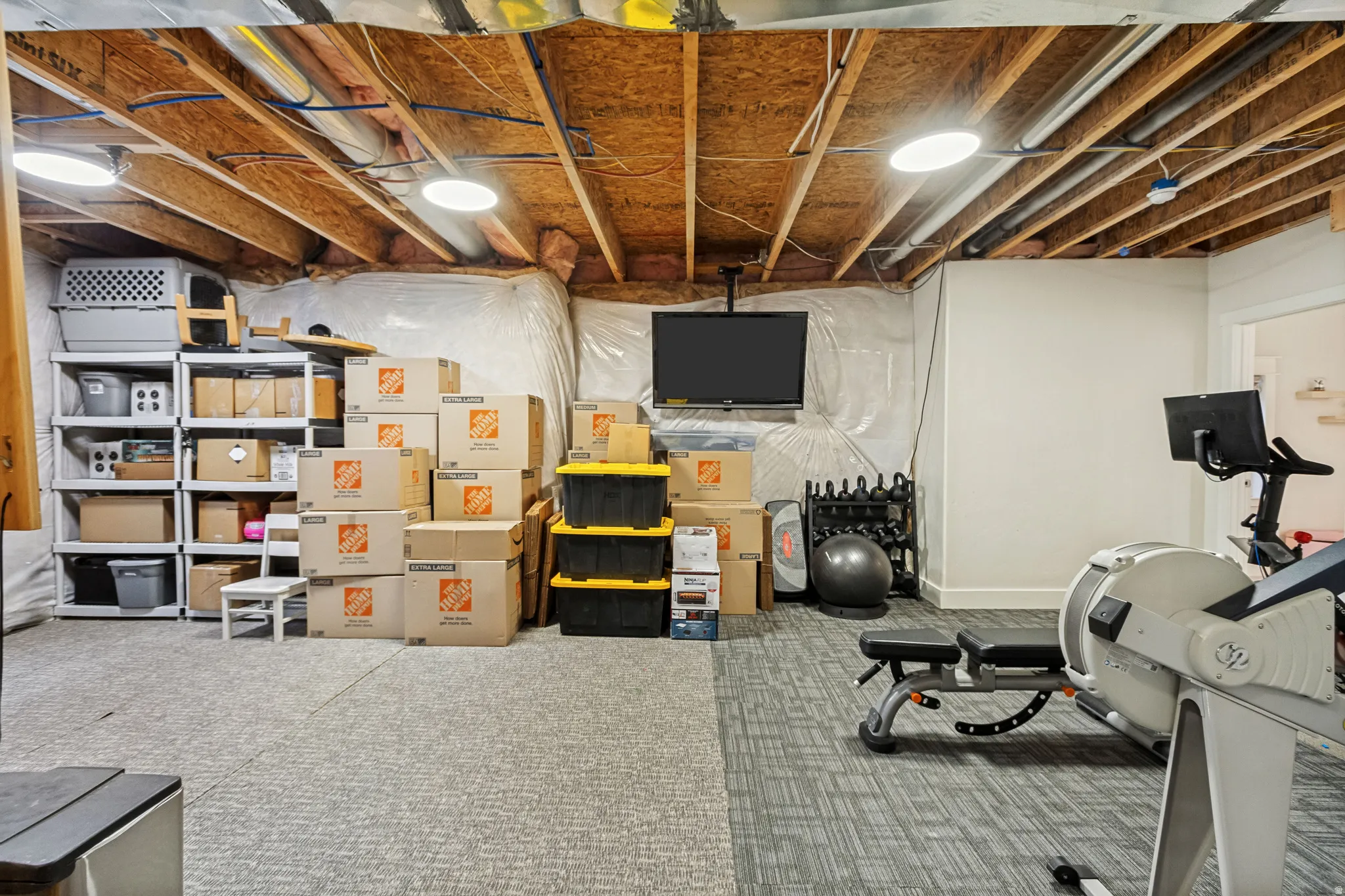 Exposed wood beam ceiling, recessed lighting, and carpeted flooring
