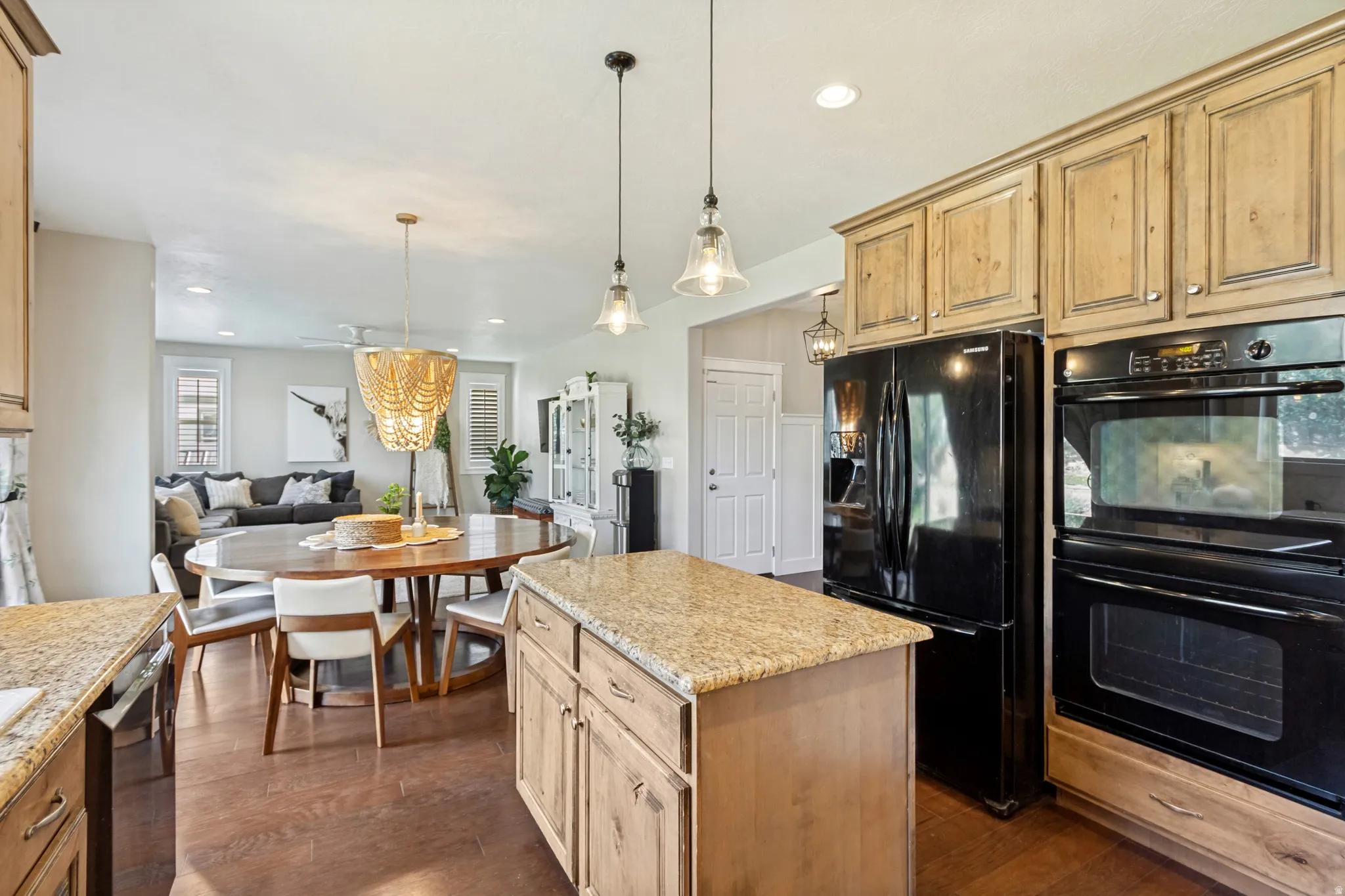 Kitchen featuring wood-finish cabinetry, granite countertops, and built-in appliances