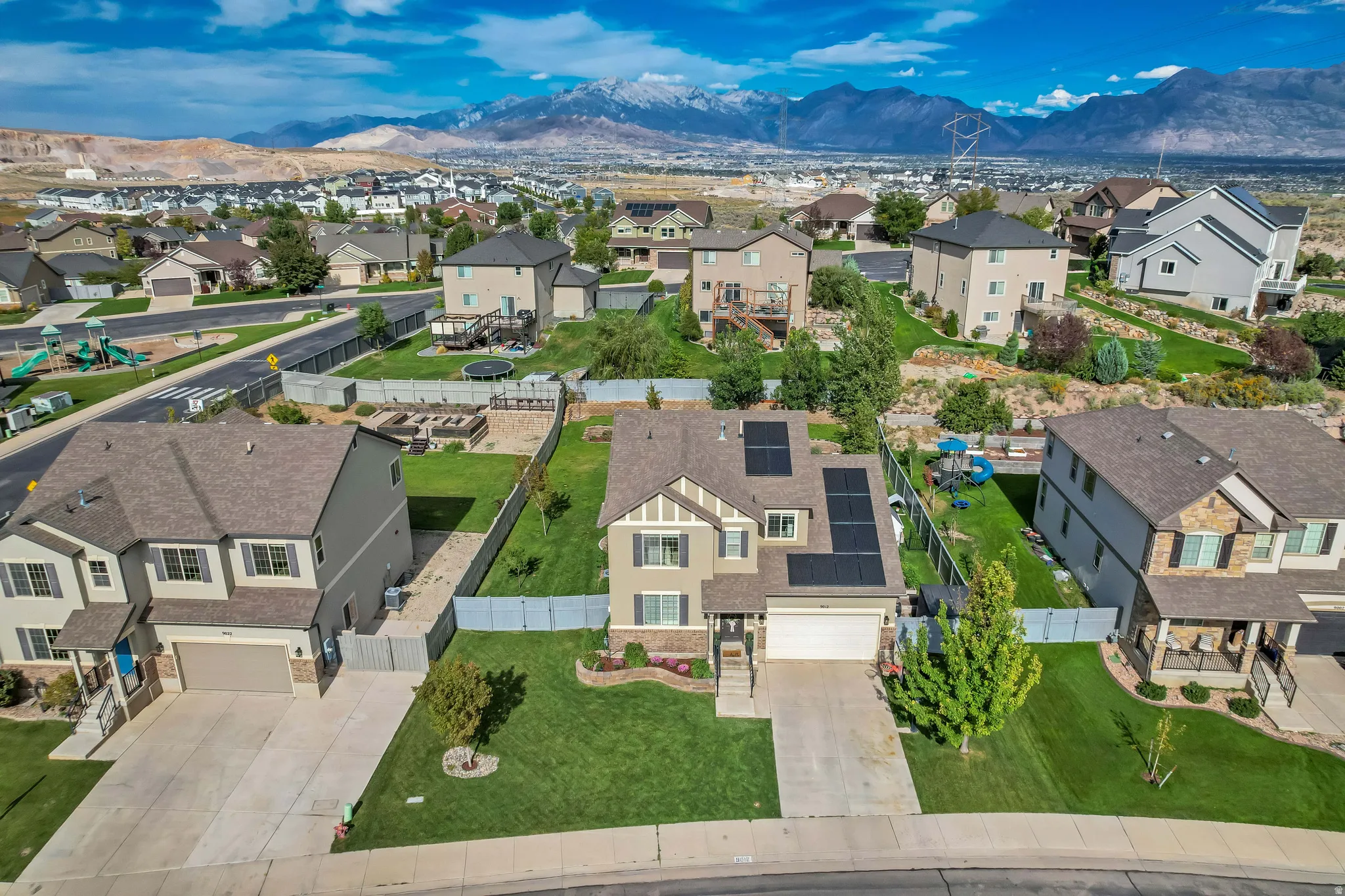 Residential property featuring a two-story design, attached two-car garage, and solar panels