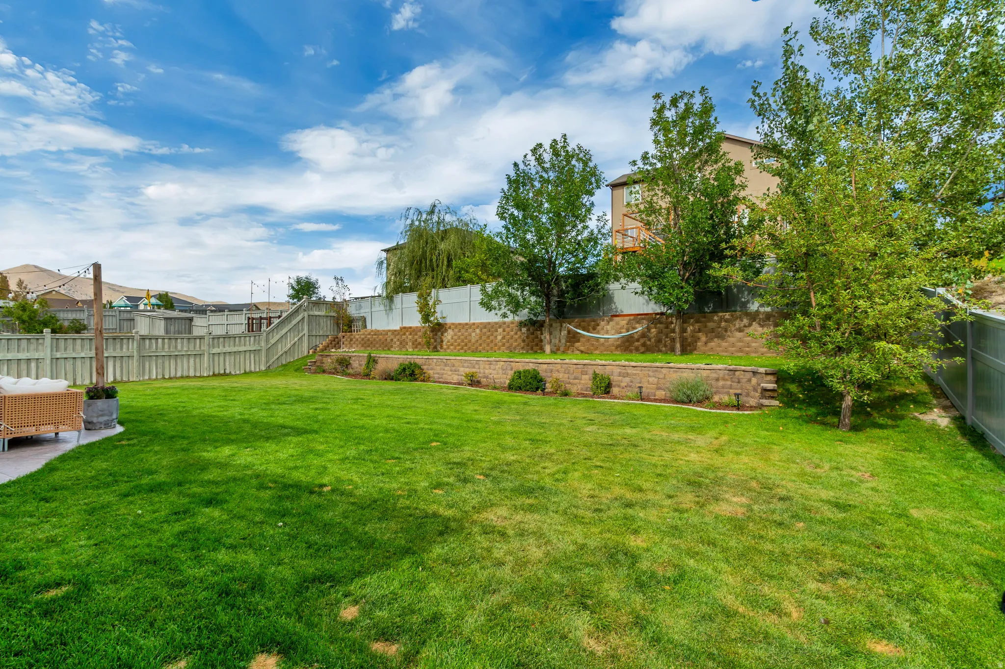 Expansive lawn area with a concrete patio