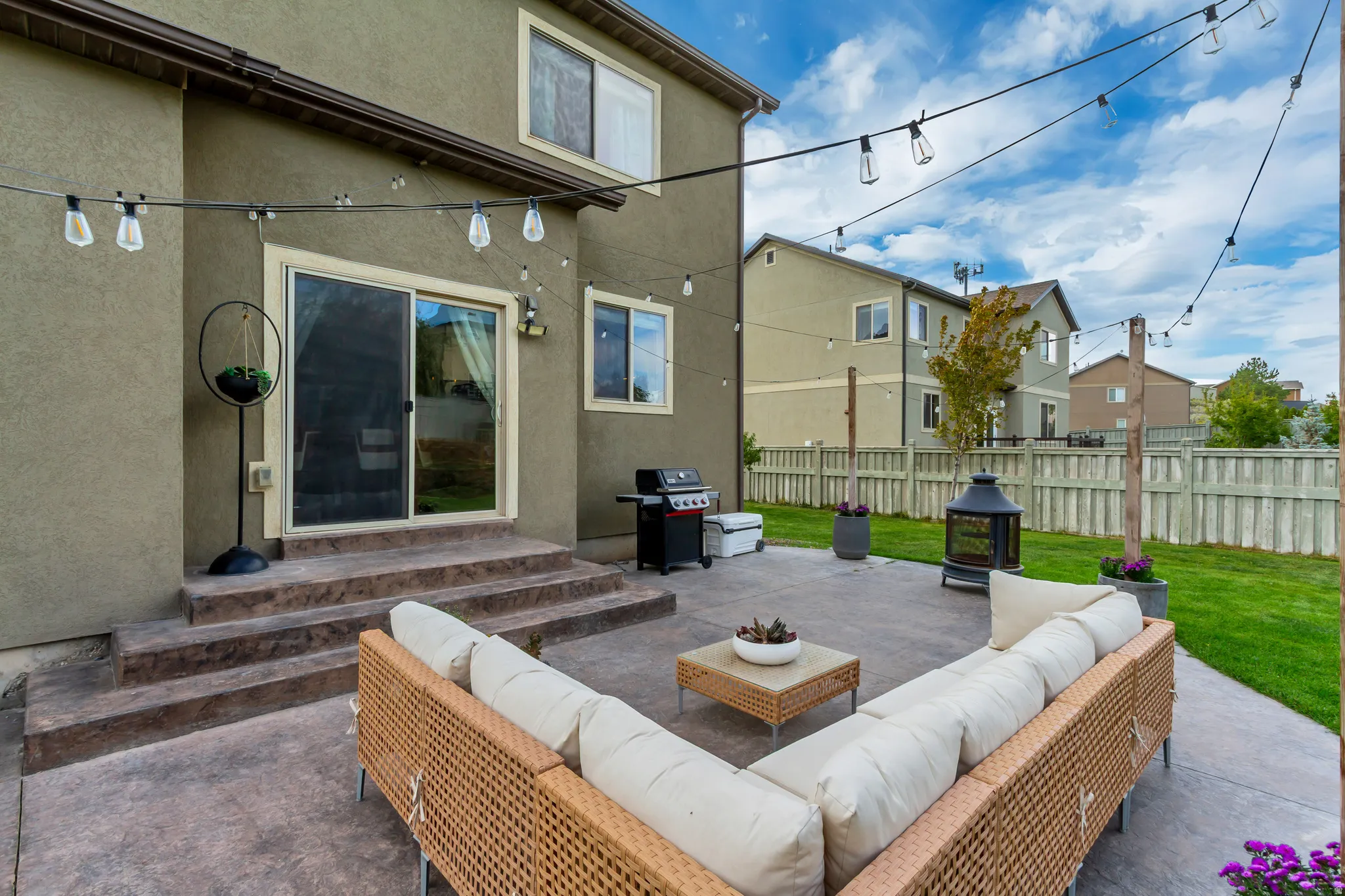 Stamped concrete patio with integrated steps and a sliding glass door
