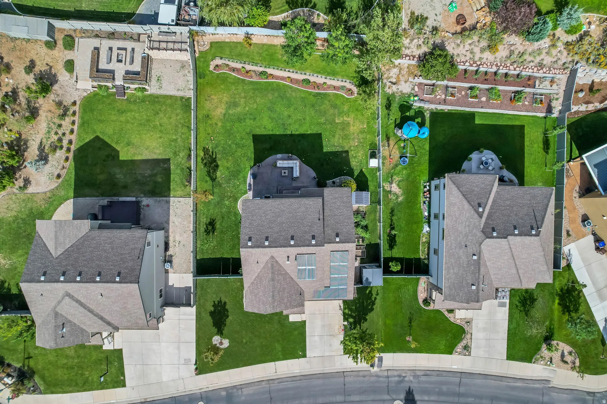 Expansive, manicured backyard with a concrete patio