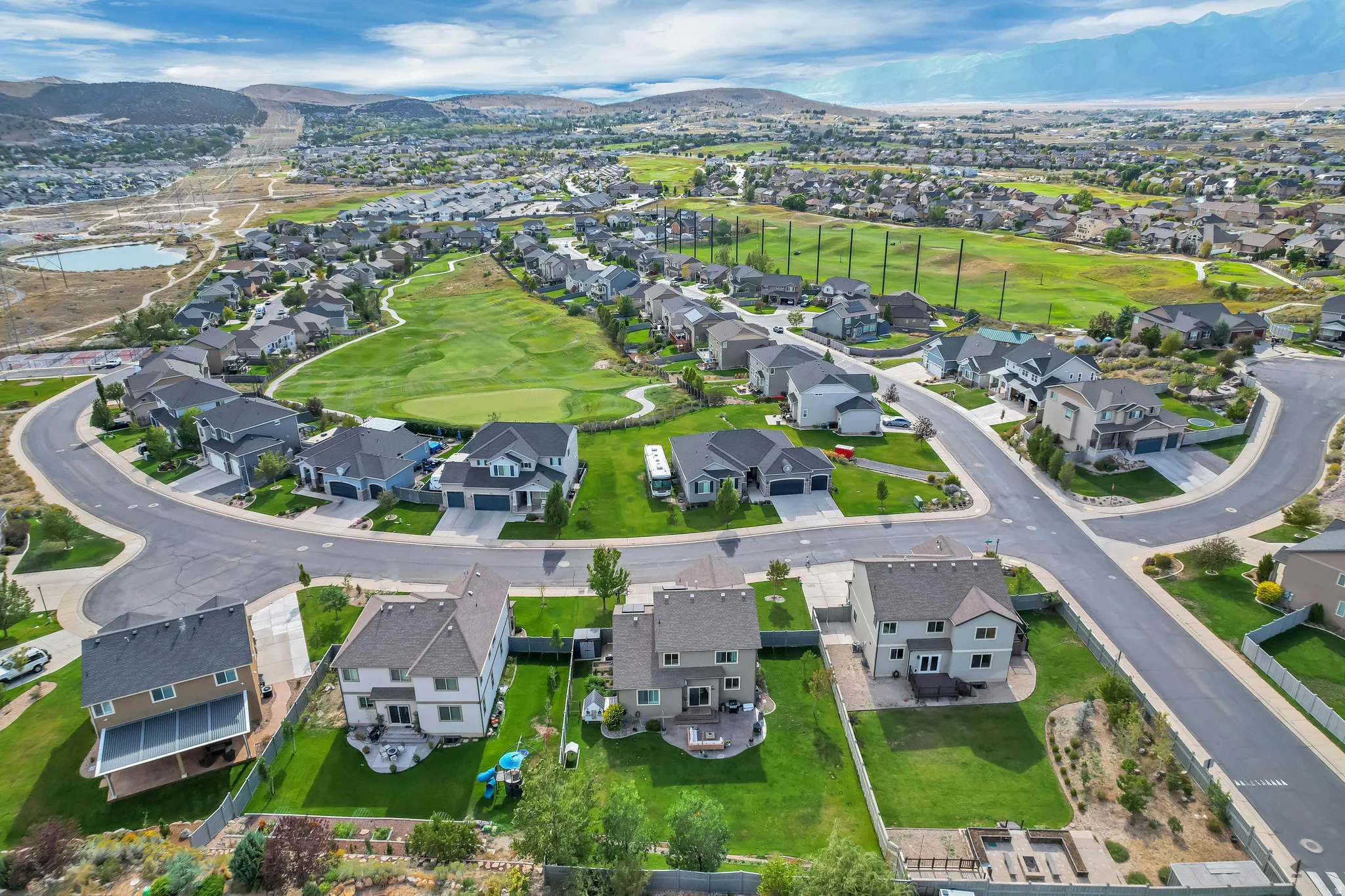 Residential neighborhood with mature landscaping and mountain terrain