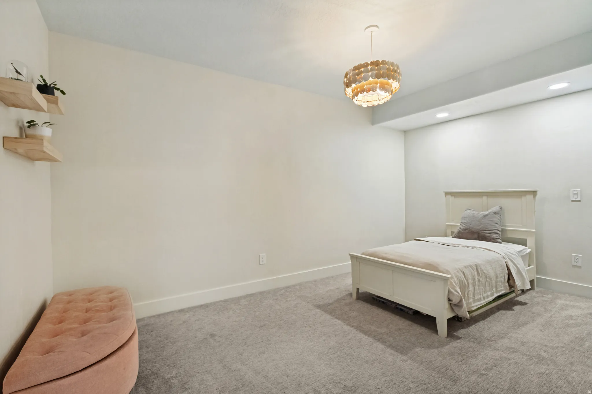 Neutral wall paint, light gray carpeting, recessed ceiling lighting, and a decorative ceiling light fixture