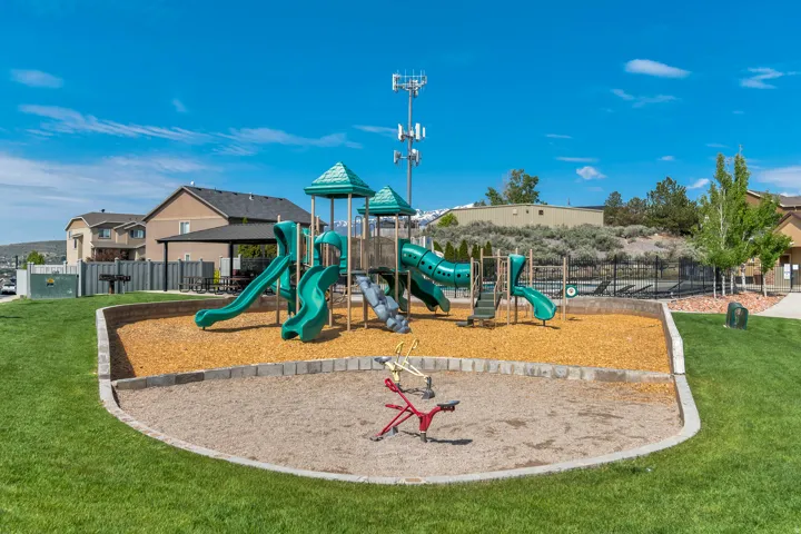 Community playground featuring slides, climbing structures, and a spring rider